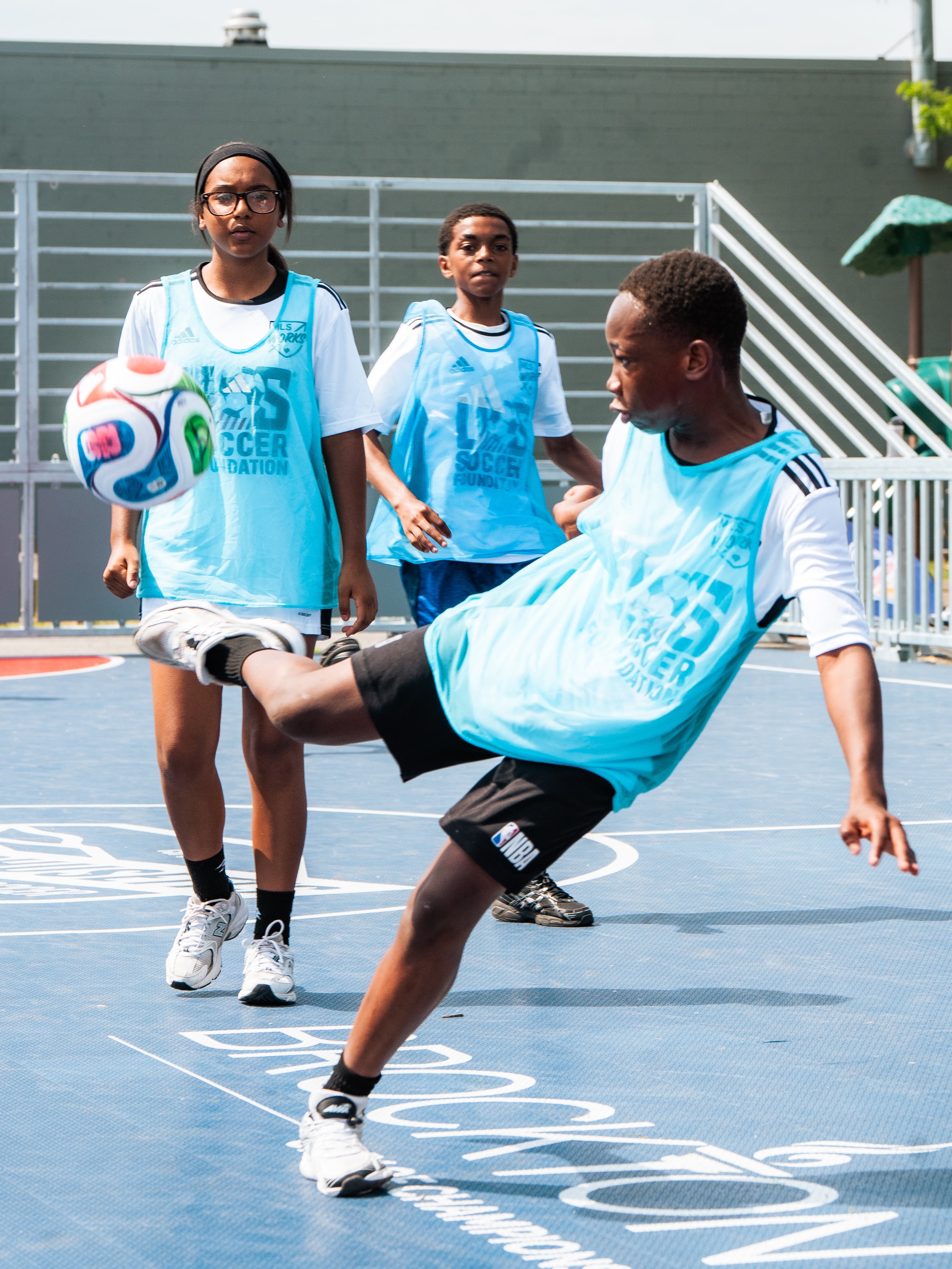 VDYF youth soccer players training on court