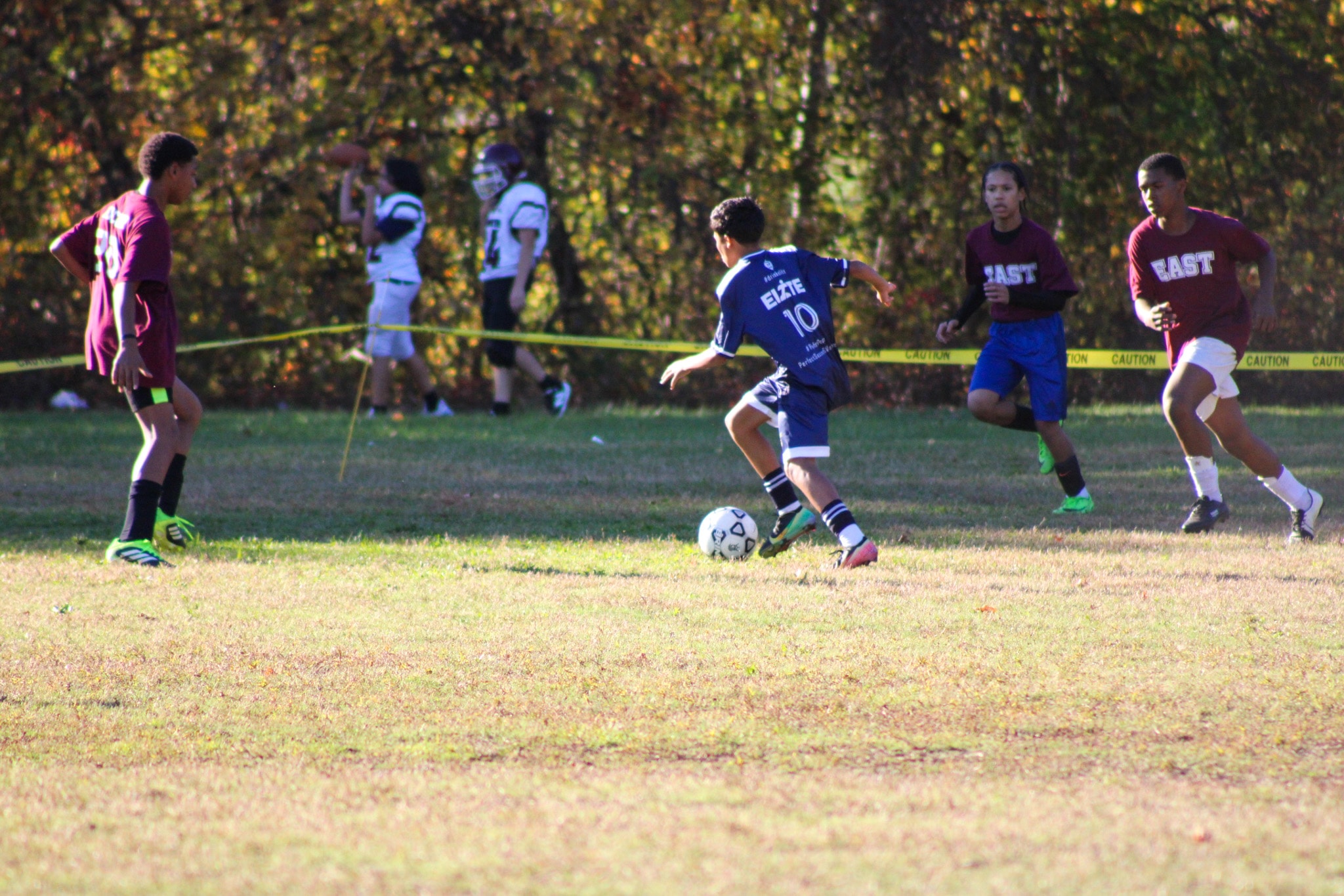 Youth soccer match in action on grass field