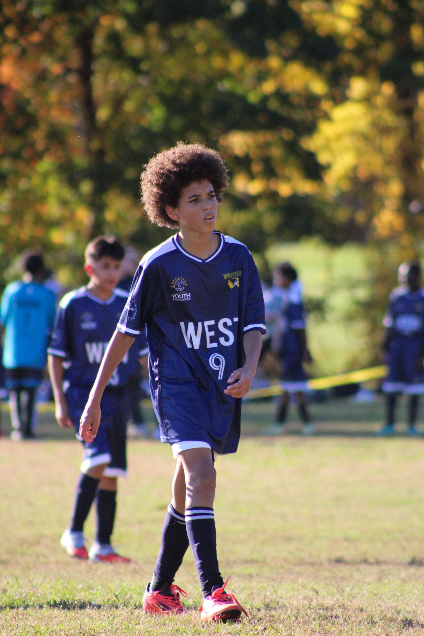 Youth soccer players in ELITE jerseys during a game